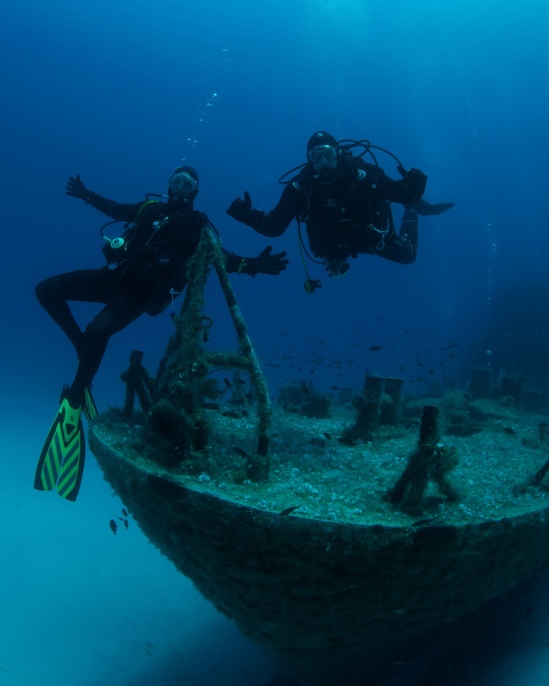 Divers on the wreck of the p31 at Comino